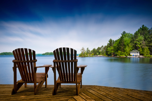 two adirondack chairs on dock