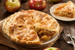 apple pie on a table with apples