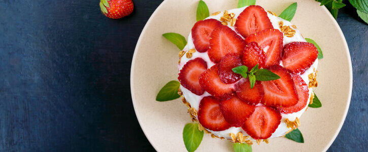 Strawberries in a bowl on a cake.