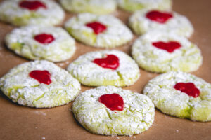 Grinch holiday cookies with powered sugar and red hearts