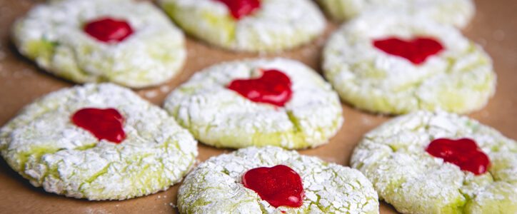 Grinch holiday cookies with powered sugar and red hearts