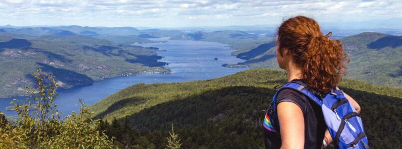 woman on top of mountain looking at view.